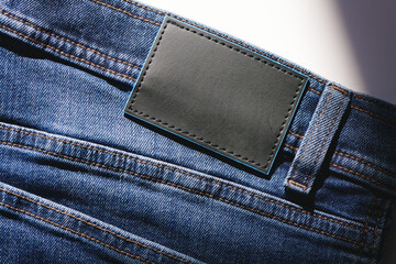 Empty rectangular leather label on the back of blue jeans. Style and authenticity of denim look.