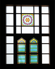 Sun light coming through the colorful stained glass window of a mosque.