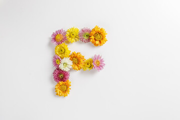Letter F made of real natural flowers.