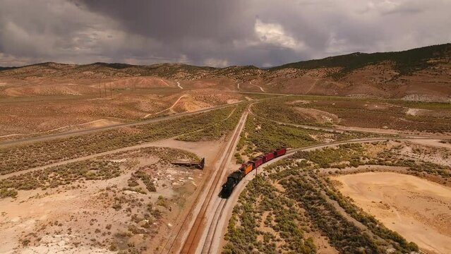Aerial Forward Shot Of Railway Moving On Railroad Track In Desert Area During Sunny Day - Ely, Nevada