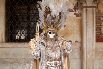 Venice, Italy - February 2022 - carnival masks are photographed with tourists in San Marco square