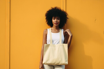 young curly-haired woman with a shopping bag around her neck. - 734272596