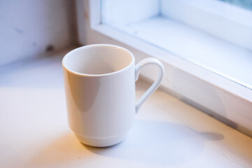 Selective focus photo. Empty white cup.