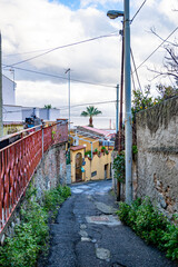 Small glimpse of a road leading towards the sea in the city of Messina - Italy