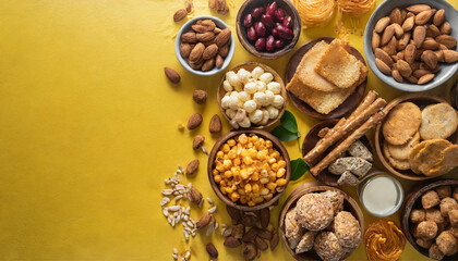 Fototapeta na wymiar top view of various snacking on yellow background with empty space