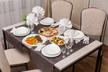 Table set up for four persons in a cafe, cafeteria, restaurant.
