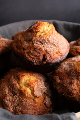 Banana Cinnamon Muffins Served in a Large Bowl: Close-up view of a linen-lined basket full of freshly baked breakfast muffins