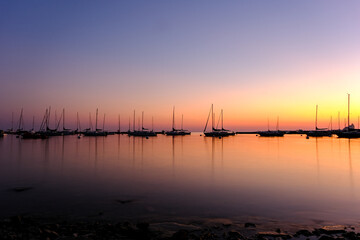 Fototapeta na wymiar Sunset at the marina harbor with many boats