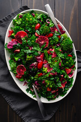 Blood Orange and Tuscan Kale Salad Arranged on a Large Platter: Fresh salad made with kale,...
