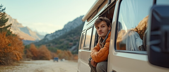 Man looks through the Campvan window, on the road