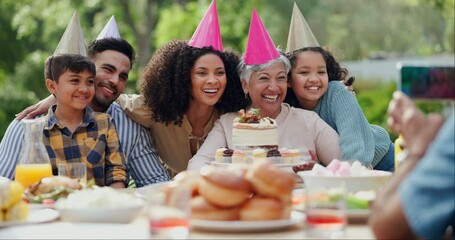 Family, birthday party and people with phone for photo in garden with cake, happy and love. Grandmother, parents and children with smartphone for memory, dessert and home in backyard on social media