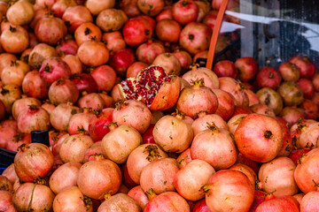 Many pomegranates for sale at the market. Fruit background