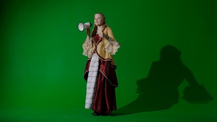 Woman in ancient outfit on the chroma key green screen background. Female in renaissance style...