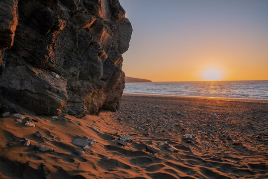 Glorious vibrant sunrise  among the volcanic rocks on Atlantic Ocean coast in Fuerteventura Island, Tarajalejo beach in Canary Islands