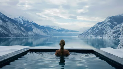 Papier Peint photo Lavable Spa A woman relaxes in a hot bath with mountains and a lake in the winter background. Ai generative