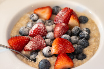 Oatmeal with Strawberries and Blueberries in a Bowl