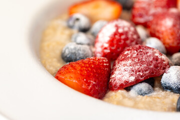 Oatmeal with Strawberries and Blueberries in a Bowl