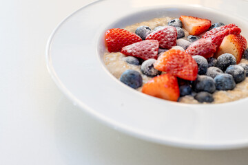 Oatmeal with Strawberries and Blueberries in a Bowl