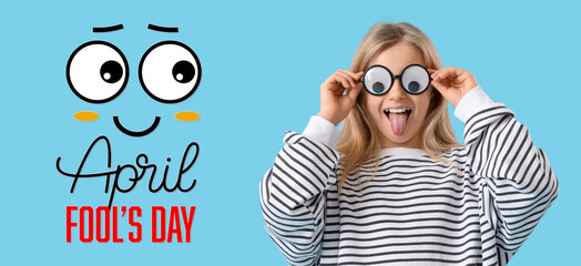 Funny little girl on light blue background. Banner for April Fools' Day
