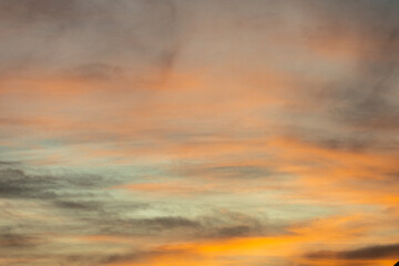 Naklejka na ściany i meble Golden, orange and blue clouds at sunset