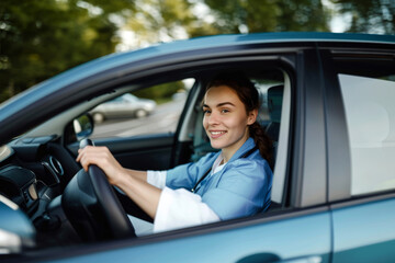 Female nurse sitting in car, going home from work. Female doctor driving car to work, on-call duty. Work-life balance of healthcare worker.