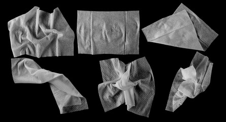 Set white disposable wet wipes isolated on black, clipping