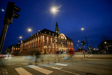Copenhagen at dusk. Night city. People at the crossing.