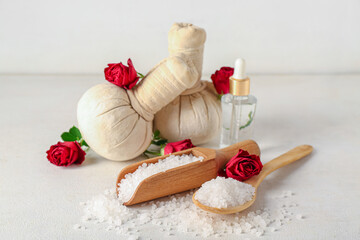Composition with spa accessories and rose flowers on light background