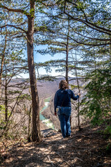 Woman Hiker Admiring Canyon River View Through Forest Trees at New River Gorge National Park