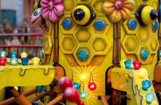 Close-up of a yellow facility with colored lights at an amusement park in Sri Lanka
