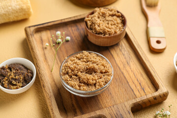Wooden board with different body scrubs on color background, closeup