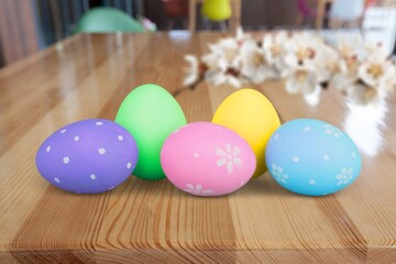 Easter concept, colored eggs with fresh flowers