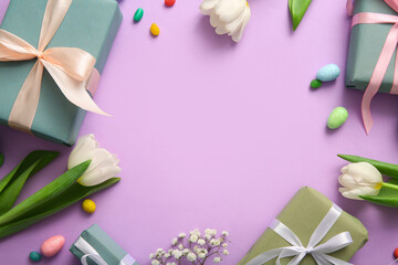 Frame made of Easter eggs with flowers and gift boxes on purple background
