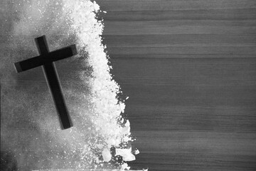 Christian Cross in white ashes on wooden desk