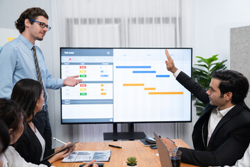 Project manager planning schedules for business task at meeting room, Gantt chart software show on...