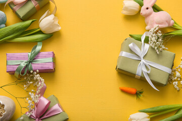 Easter bunny with gift boxes and flowers on orange background