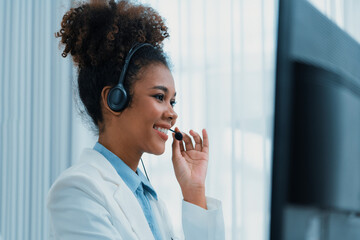 African American businesswoman wearing headset working in office to support remote crucial customer...