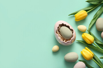 Holder with Easter eggs and tulip flowers on turquoise background