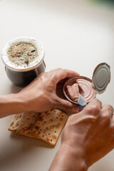 spreading cookies with pâté while drinking mate