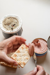 spreading cookies with pâté while drinking mate