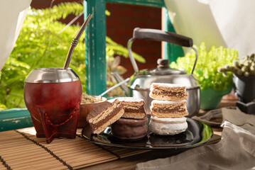 Argentine Alfajor with chocolate and meringue filled with dulce de leche and mate 