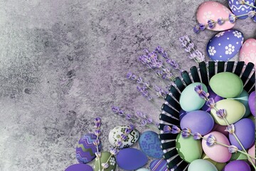 Easter eggs. Purple, blue and golden eggs with lavender on a background.
