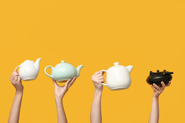Women with teapots on yellow background