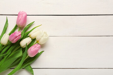 Beautiful tulip flowers on white wooden background. International Women's Day celebration
