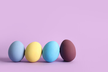 Fototapeta na wymiar Painted Easter eggs on purple background