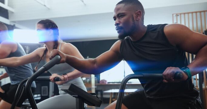 Exercise, spin class and people in gym for training, intense workout and fitness for health club. Sports, cardio and group on cycling equipment or machine for performance, endurance and wellness