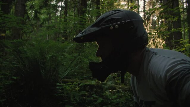 Extreme Sports Athlete Putting on Mountain Bike Helmet