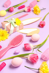 Composition with hairdresser's supplies, spring flowers and Easter eggs on color background