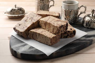 Tasty chocolate halva on wooden table, closeup