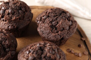 Delicious fresh chocolate muffins on table, closeup